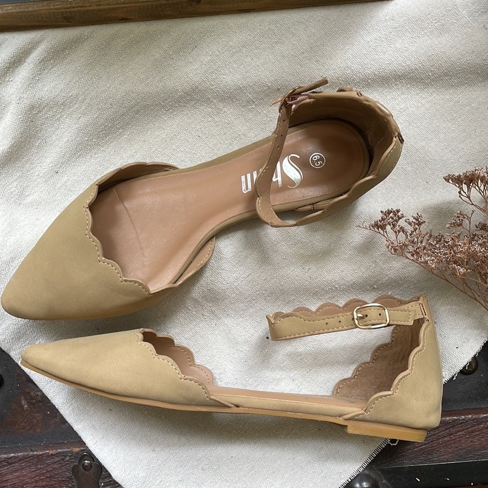 Tan scalloped flats with ankle strap.